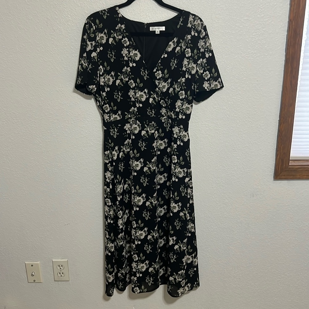 Fully lined, below knee length, black, off-white, and green floral.